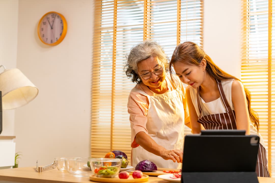 Grandmother teaching a family recipe in the kitchen